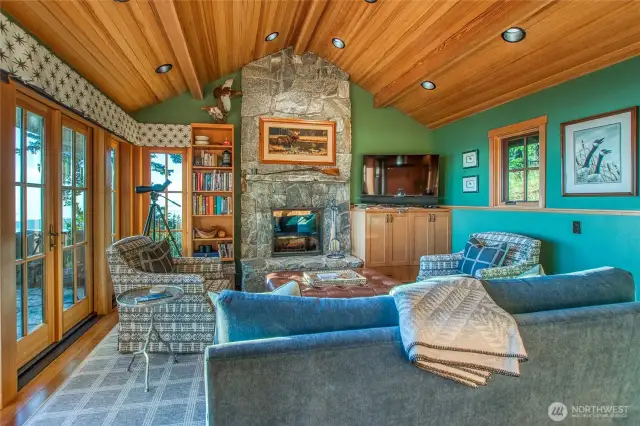 Main house living room with wood fireplace. Local wood material adds warmth to each room.