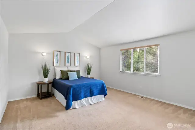 Wonderful primary bedroom with view out on the back garden.