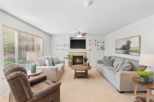 Family room has one of two fireplaces.