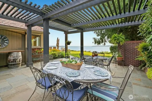 The Chef’s kitchen with oversized granite island, custom cabinets with pull out drawers offers hidden gems: trash compactor, double-oven, Sub-Zero refrigerator, undercounter lighting and floor lighting with westerly views at every turn.