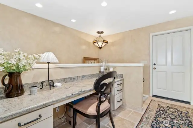 Off the kitchen is the granite planning desk that leads to either the oversized 3 car garage and or the lower level.