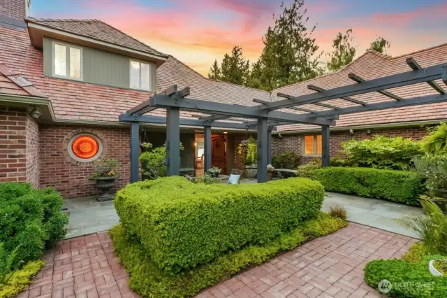 A beautiful bluestone courtyard entrance marked with arbors and manicured NW gardens welcomes you to this rare estate situated on a flat lot with fully fenced backyard.