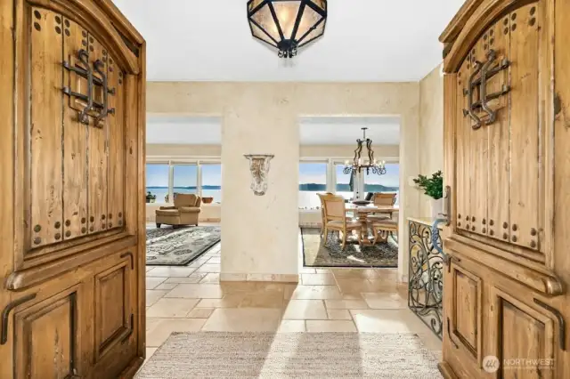 Enter through the magnificent solid wood doors, welcomed by natural stone floors and rooms filled walls of windows, that bring in the sunlight and beautiful vistas.
