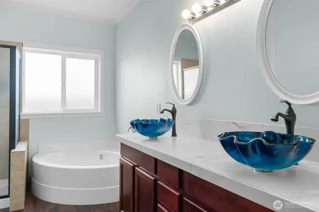 Unique blue vessel sinks on the vanity in the Primary Bathroom.