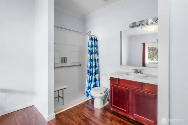 Another view of the open bathroom showing the vanity and shower.