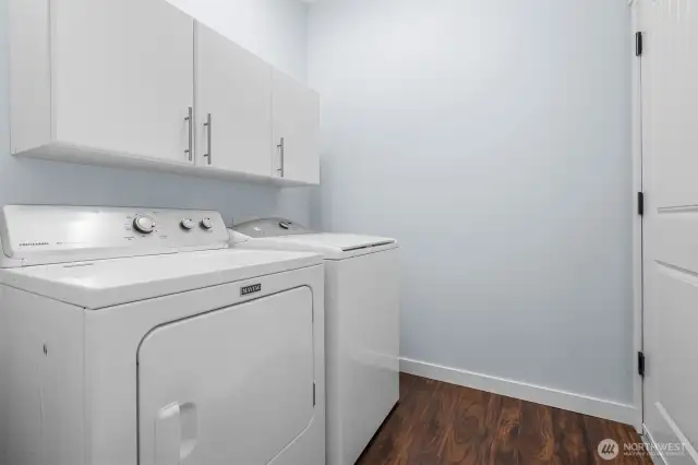 Washer and dryer stay in laundry room with cabinetry for your cleaning supplies. Gives access to attached garage.