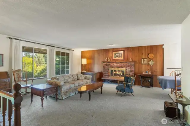 Spacious living room with brick fireplace.