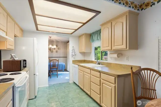 spacious kitchen with window overlooking backyard