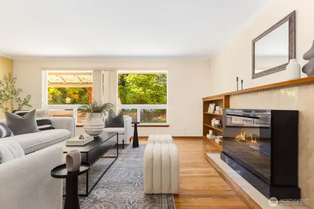 Fireplace insert stays with the home or simply remove for wood burning option.  Large windows let in plenty of light to check out your amazing garden space