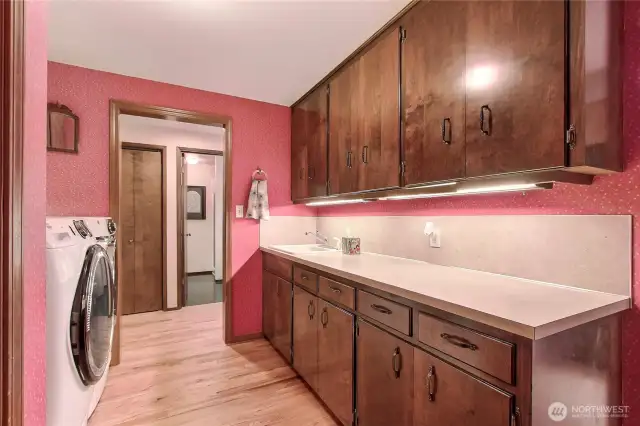 Laundry room with tons of cabintry.