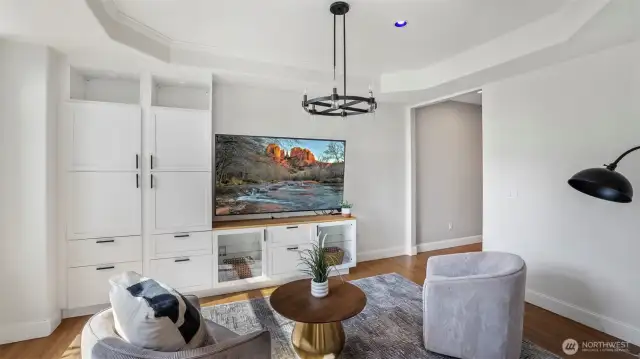 The built-in shelving and large white cabinets create a stylish focal point while giving the space a warm and welcoming feel!