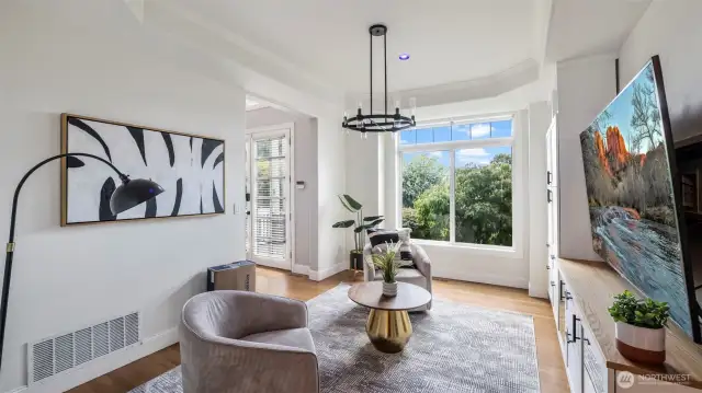 This elegant living space features a beautiful open layout, perfect for relaxing as soon as you walk in, with plenty of room to customize with your choice of furniture and a large window that fills the room with natural light