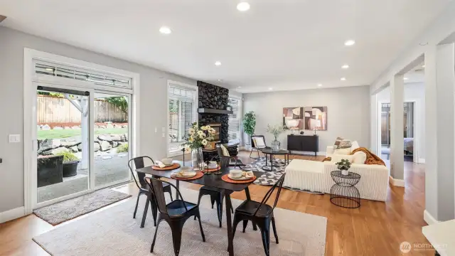 A large glass sliding door is conveniently located at the center of the home near the dining area, which seamlessly flows into the spacious, open-concept second living room with an elegant design
