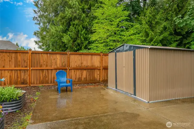 Huge concrete patio w/garden shed tucked back in corner