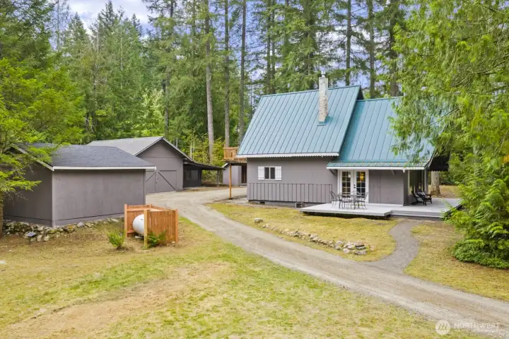 Home with newer metal roof, freshly painted exterior, and new outdoor lighting.