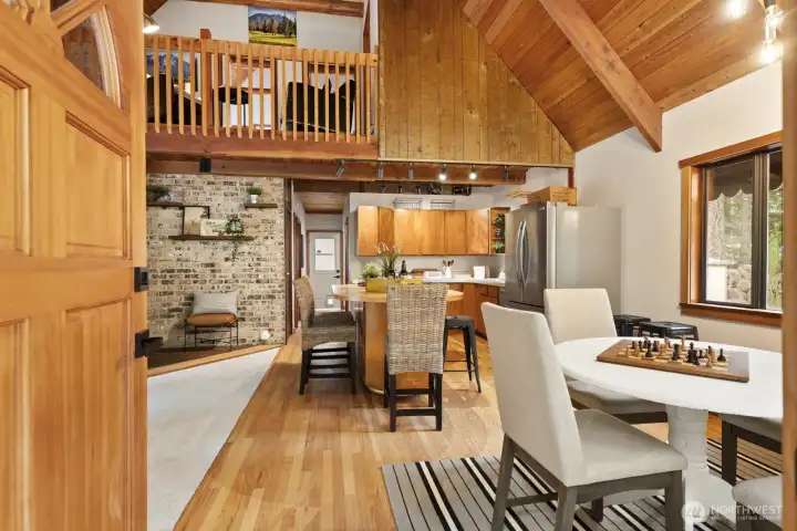 Warm, refinished hardwood floors extend throughout the main living space.