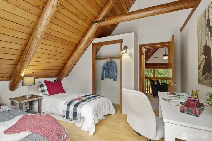 Spacious second bedroom with ample closet space, and stunning exposed beams.