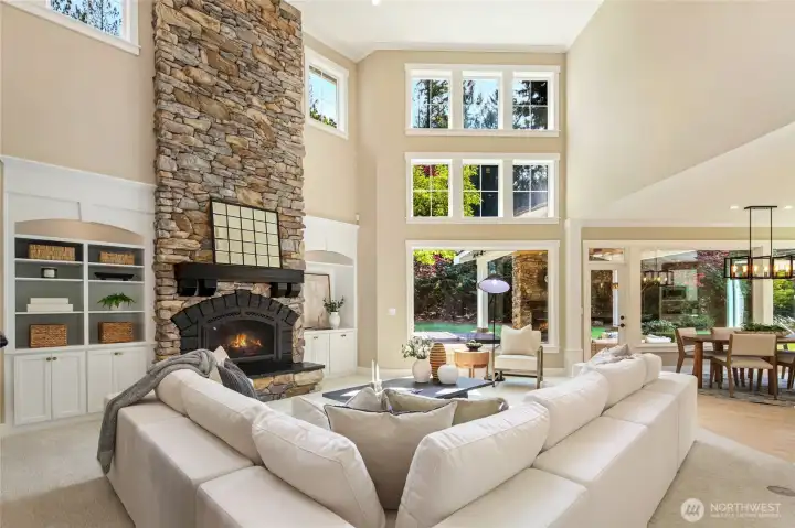 Elegant great room with stone fireplace, custom details, and soaring ceilings.