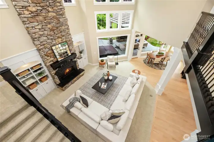 Elegant great room with stone fireplace, custom details, and soaring ceilings.
