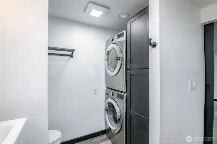 Stacked washer and dryer in primary bathroom