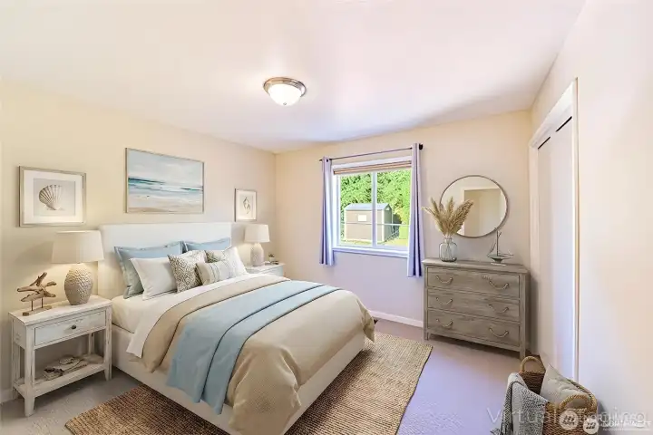 The primary bedroom offers a calm, comfortable retreat with soft natural light and a spacious layout.