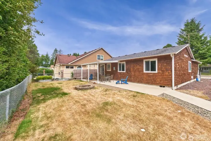 The spacious backyard includes a cozy fire-pit area and a generous side yard that offers convenient RV parking.