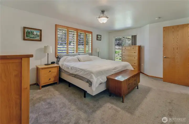 Plantation shutters and a slider to the covered back porch