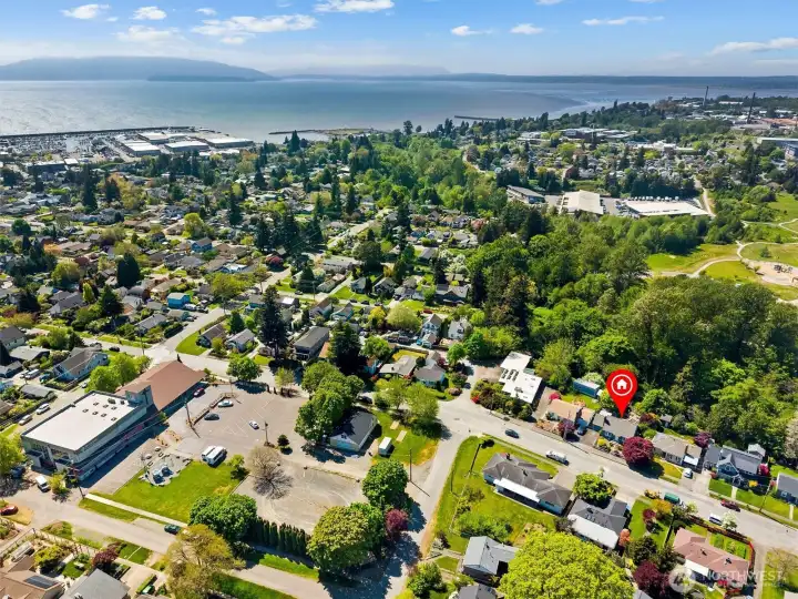 Sweeping aerial views capture the surrounding neighborhood, bay, parks, and mountain backdrop.