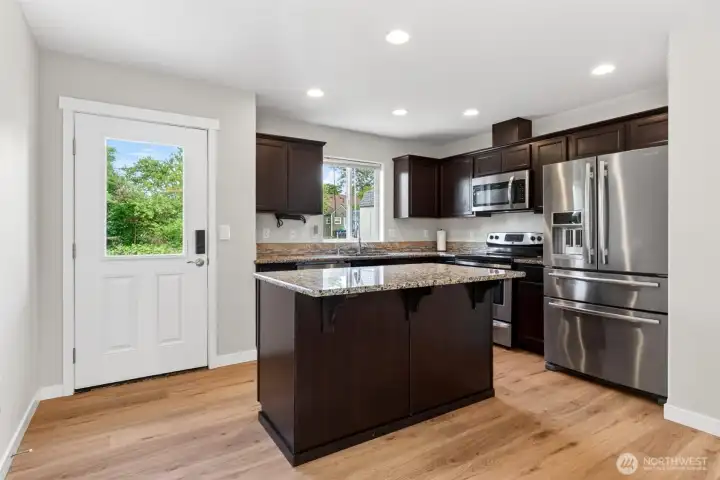 Brand new luxury vinyl plank and white trim and doors fill the first floor.