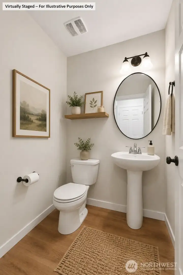 Powder room with pedestal sink is conveniently located just off the garage.