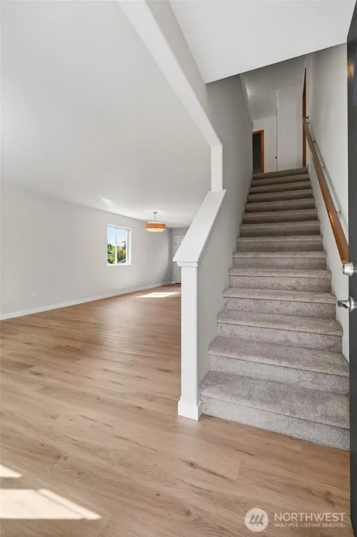 Stairs covered in new carpet and pad, lead to the generously sized second story.
