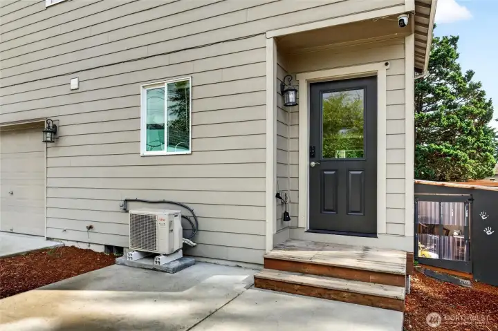 On the back side exterior you will find the mini-split fujitsu to keep you cool all summer as well as the back patio and entrance to the kitchen, perfect for coming home with all the groceries.