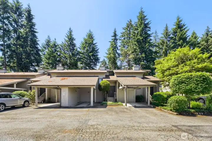 Covered carport & one open space come with the unit. There is a storage room in the carport area.