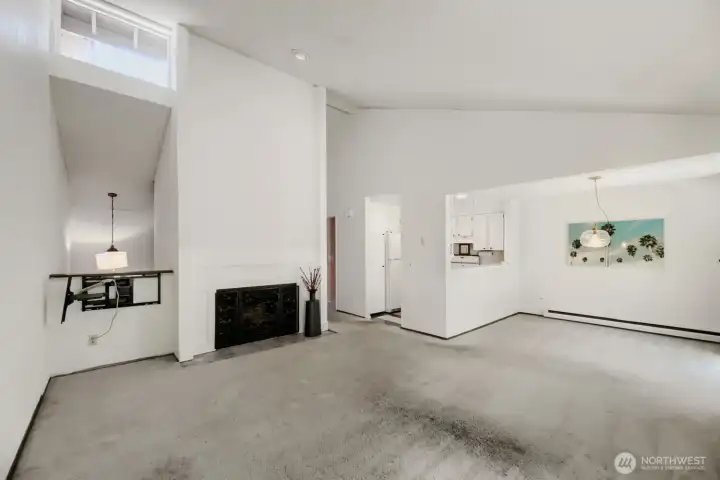 Living room with wood fireplace for those cool winter nights. The high transom window brings in the natural light.