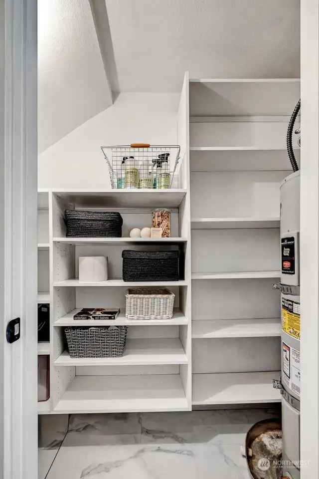 Walk-in pantry storage area adjacent to the ½ bath laundry room. Custom built-in California Closets to stay organized.