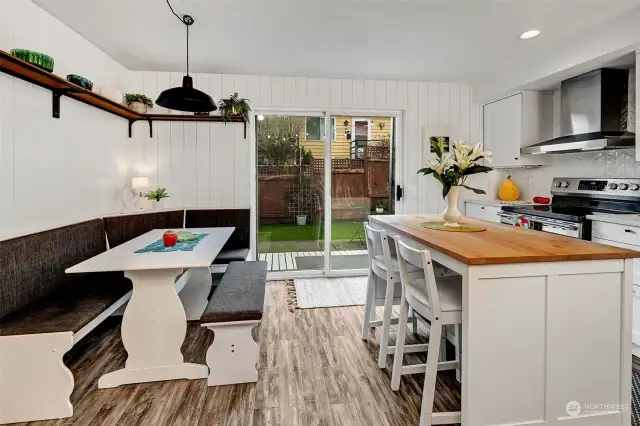 The eat-in kitchen has a cozy banquette and a breakfast bar.