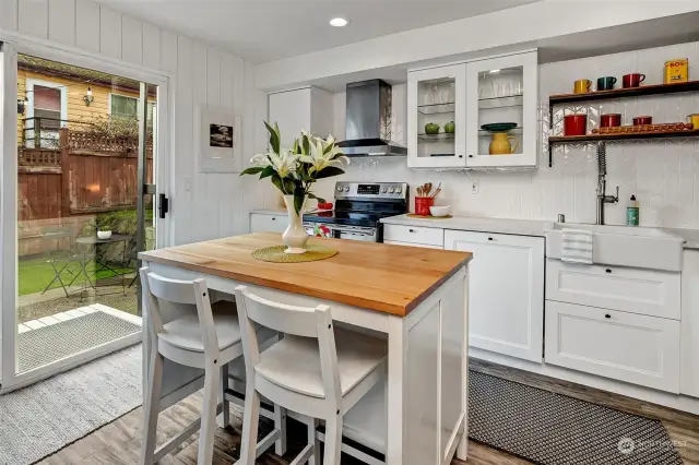 The updated kitchen is light and bright, with access through the slider to the back patio area. A perfect spot for grilling all summer long.