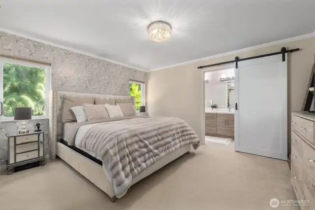 Spacious primary bedroom features a beautifully updated en-suite bath and a custom-designed walk-in closet.