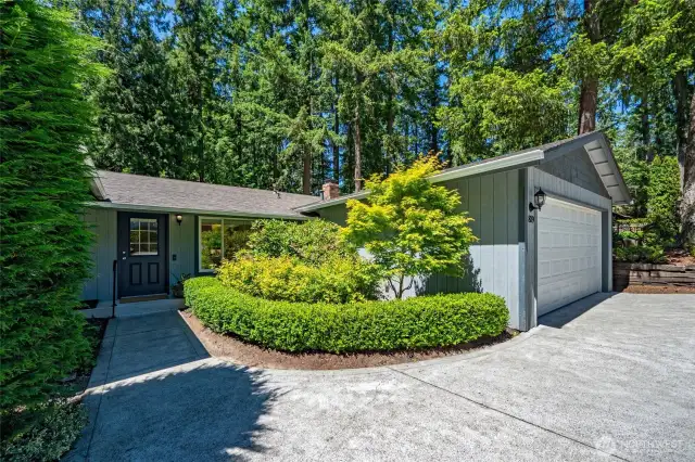 A lovely, landscaped walkway connects the driveway to the front door.