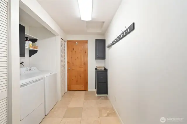 Laundry room with travertine tile floor, just off the family room.