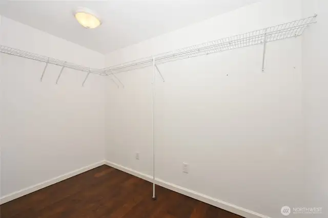 Walk-in closet with organizers and plenty of space for your wardrobe.