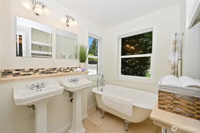 Recently remodeled primary bath with clawfoot tub & dual pedestal sinks!