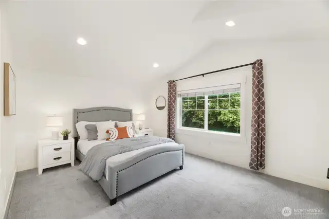 Primary bedroom with vaulted ceilings