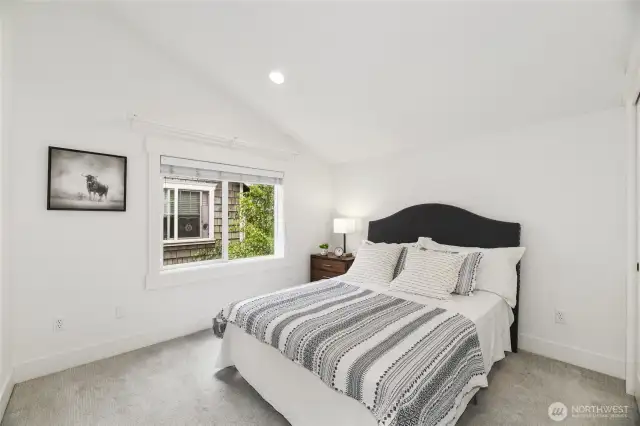Second en suite upstairs bedroom with vaulted ceilings