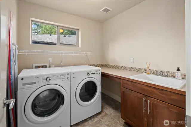 Dedicated laundry room with a sink and countertop