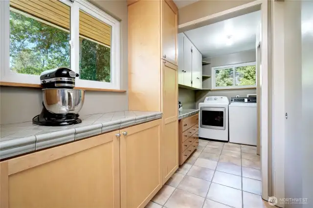 Additional kitchen storage area, large pantry, and tucked away laundry space