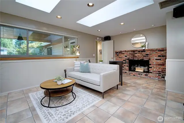 Family room or informal dining off kitchen with skylights, surround sound speaker system and wood burning fireplace.