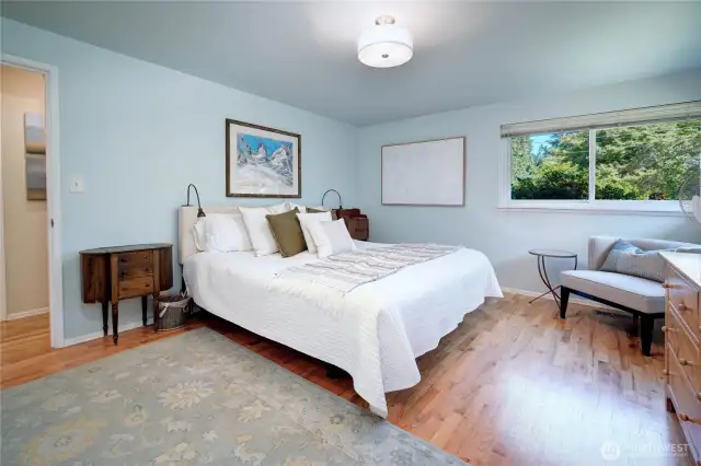 Spacious primary suite with three-quarter bathroom.