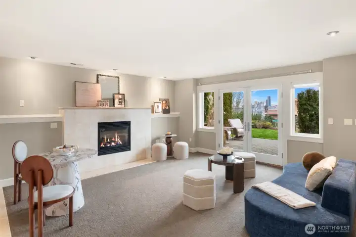 Daylight basement with fridge, sink and microwave.