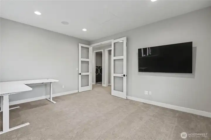 Versatile main-floor bedroom with elegant double-door entry—perfect as a guest room or sophisticated home office.